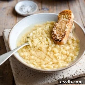 A bowl of Pastina Soup ready to be served, showcasing its comforting appeal with a garnish of herbs.