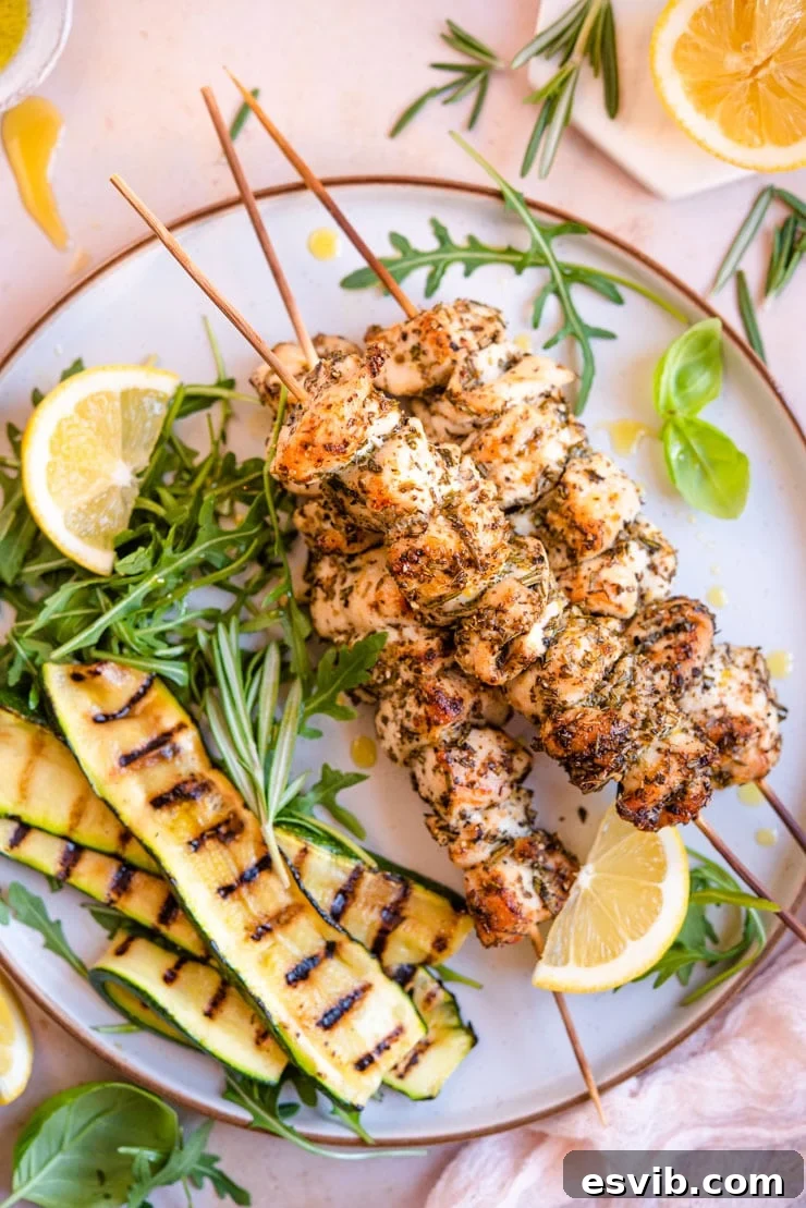 Delicious & Easy Chicken Spiedini: Tender Italian Grilled Chicken Skewers with a Zesty Herb Marinade An overhead shot of vibrant Chicken Spiedini with perfectly grilled vegetables and fresh arugula salad on the side, ready to be served.