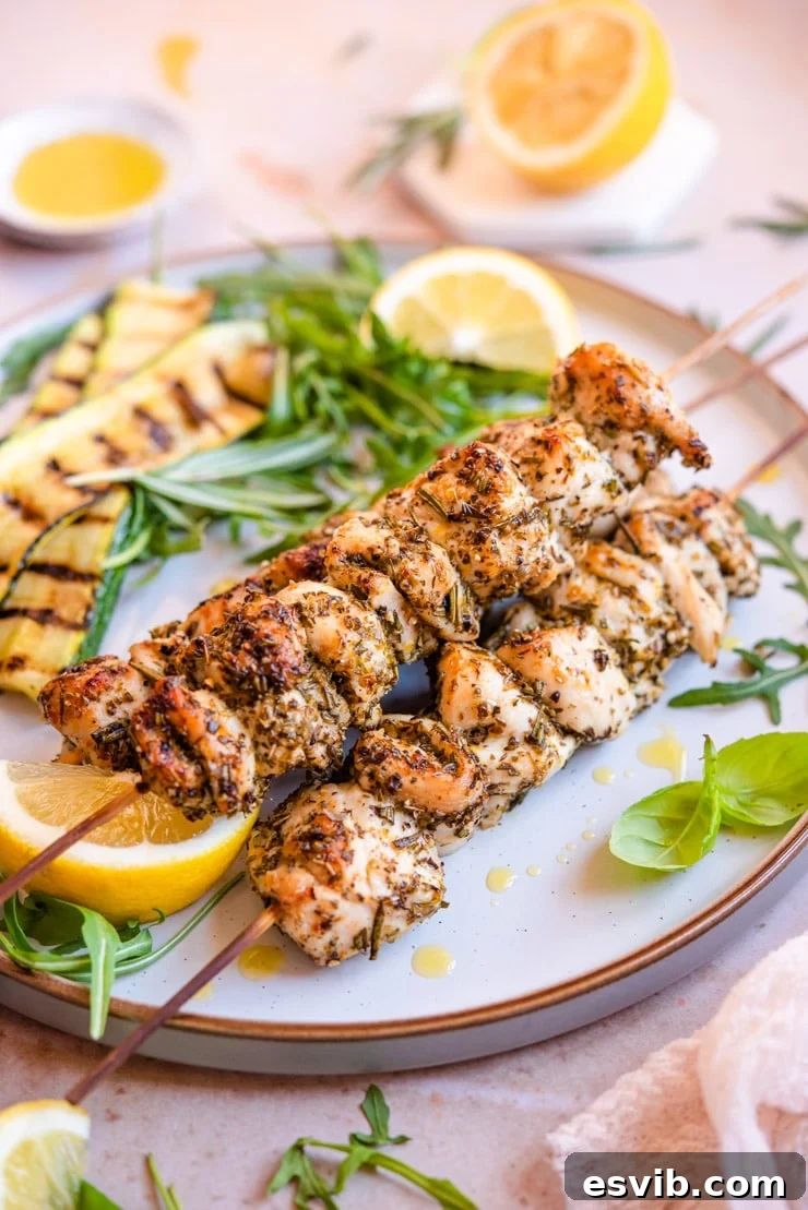 Stacked Chicken Spiedini Skewers A beautiful side shot of three perfectly grilled chicken spiedini skewers artfully stacked on top of each other, showcasing their golden-brown char and juicy texture.