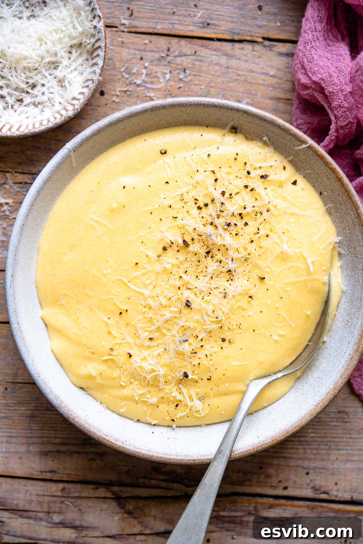 An overhead shot of creamy polenta in a bowl, showcasing its smooth, golden texture