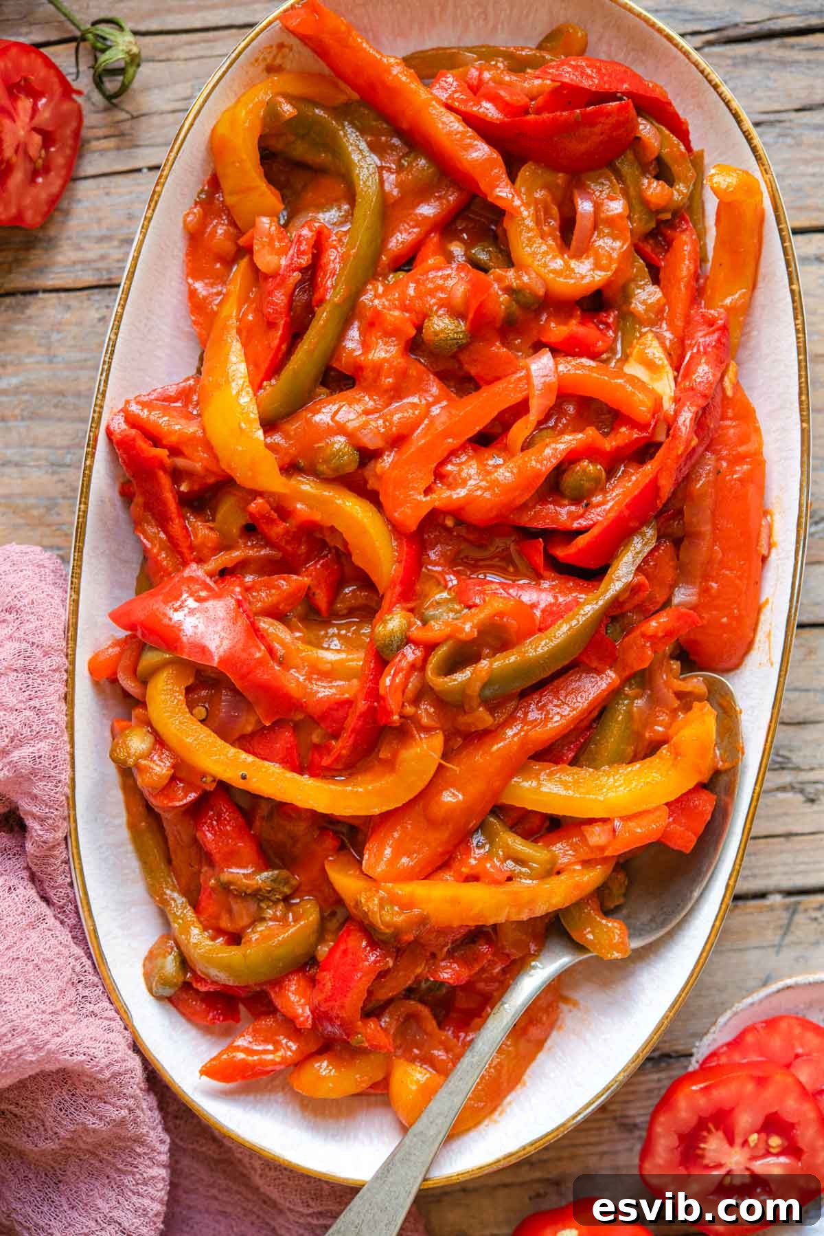 La Peperonata Italian Pepper Medley 2 An overhead shot of vibrant peperonata on a serving plate, garnished with fresh herbs
