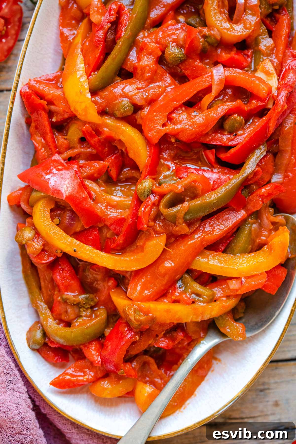 La Peperonata Italian Pepper Medley 6 A close-up shot of rich, tender peperonata served on a pristine white plate, ready to be enjoyed