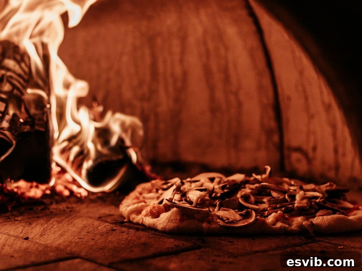 A photo of a pizza cooking inside a wood-fired pizza oven, showing the intense heat and flame.