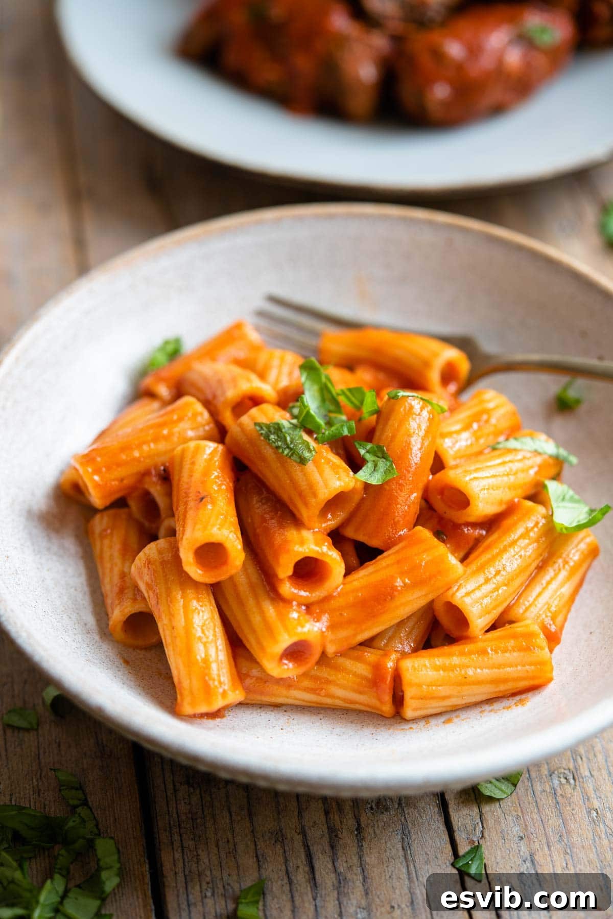 A side shot of pasta with tomato sauce in a bowl