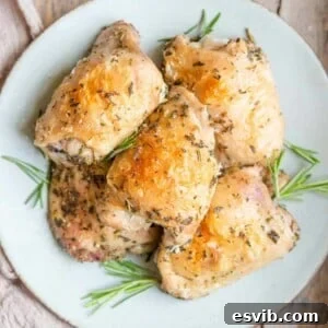 A square image of baked chicken thighs on a plate