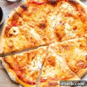 A square image of a four cheese pizza cut into slices, with a rich, inviting texture of melted cheese.