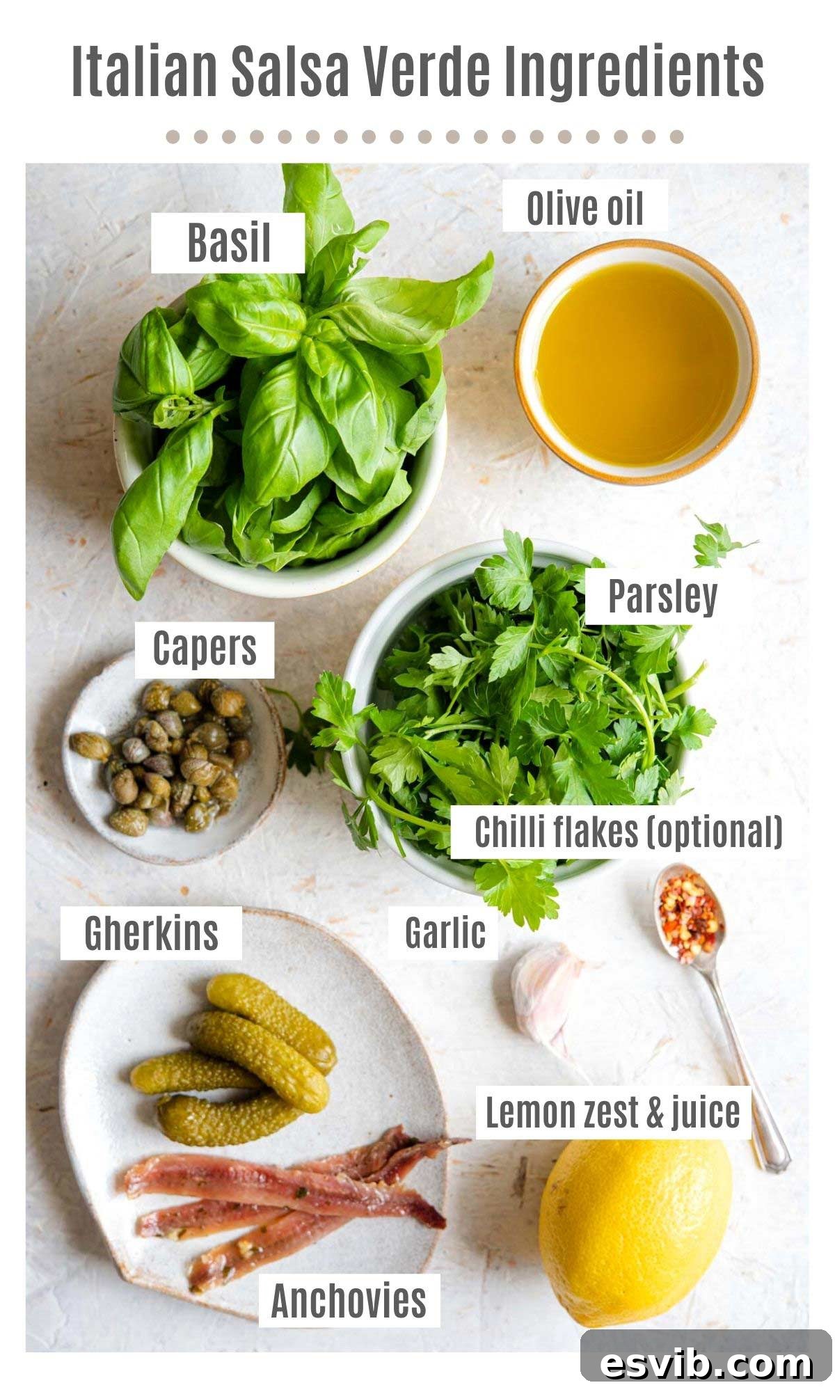 Zesty Italian Green Sauce 3 An overhead flat lay of all the fresh ingredients required to make authentic Italian Salsa Verde, including basil, parsley, garlic, anchovies, capers, gherkins, lemon, and olive oil.
