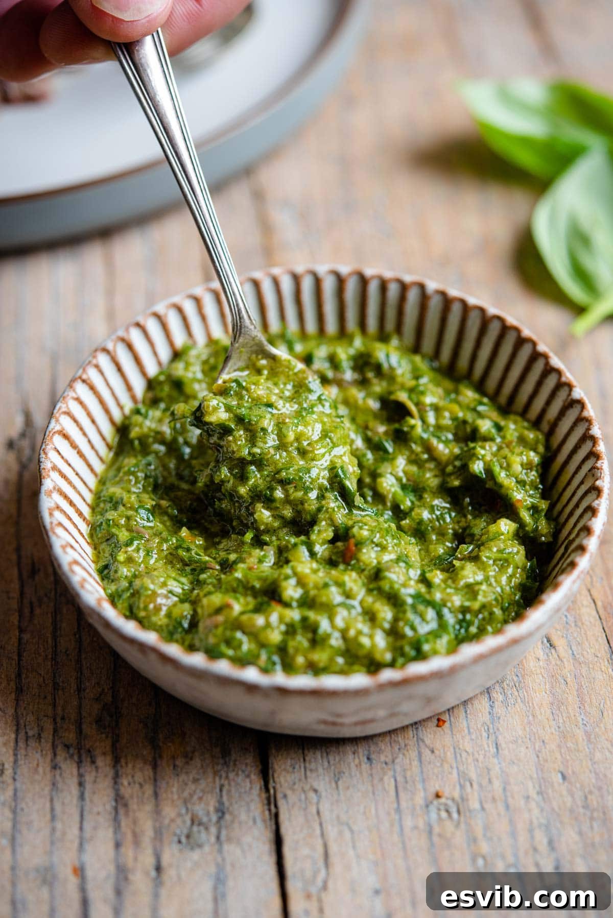 Zesty Italian Green Sauce 5 A close-up shot of vibrant green Italian Salsa Verde served in a small white ramekin, highlighting its texture and freshness.