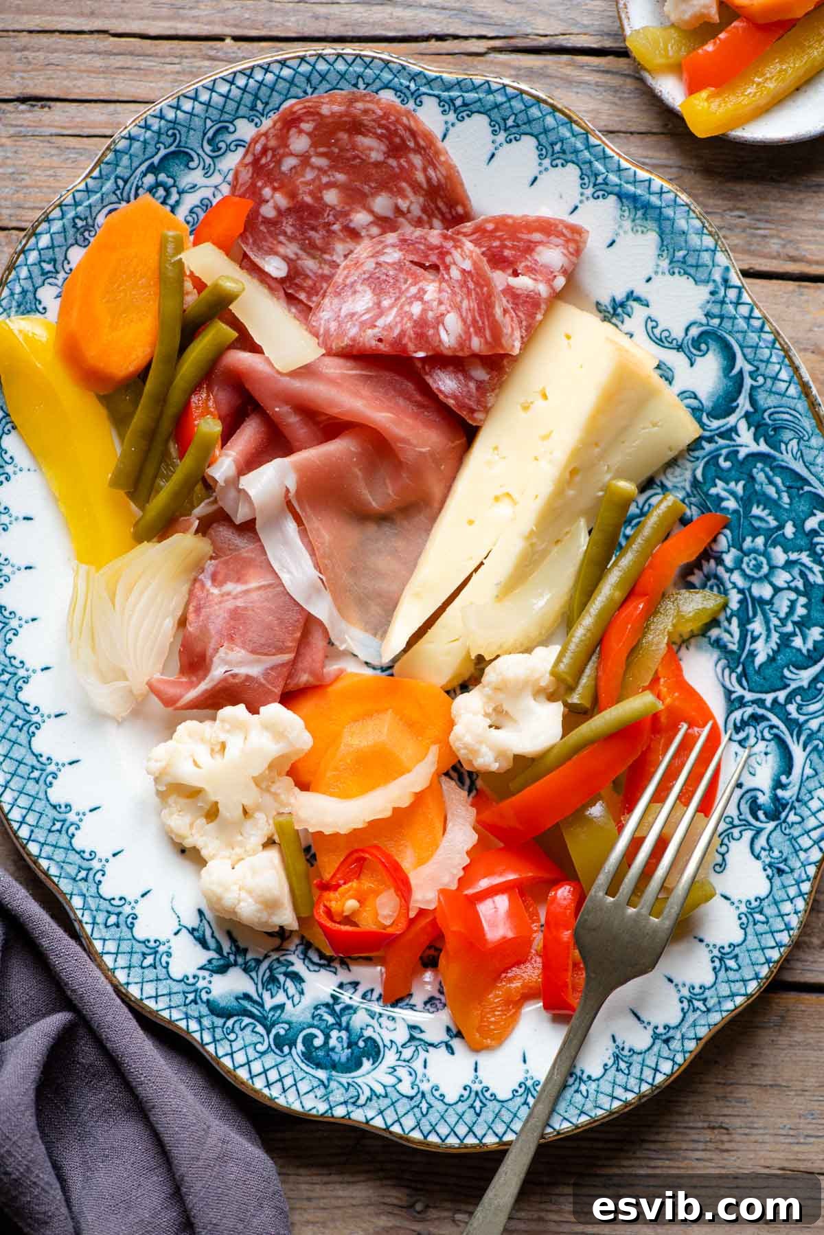 Italian Garden Style Pickles 5 Italian pickled vegetables (Giardiniera) served on a platter with assorted cured meats and cheeses, perfect for an antipasto spread.
