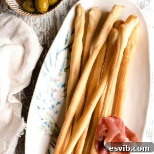 Grissini: Italy's Signature Crispy Breadsticks 6 A square image of Italian breadsticks on a plate
