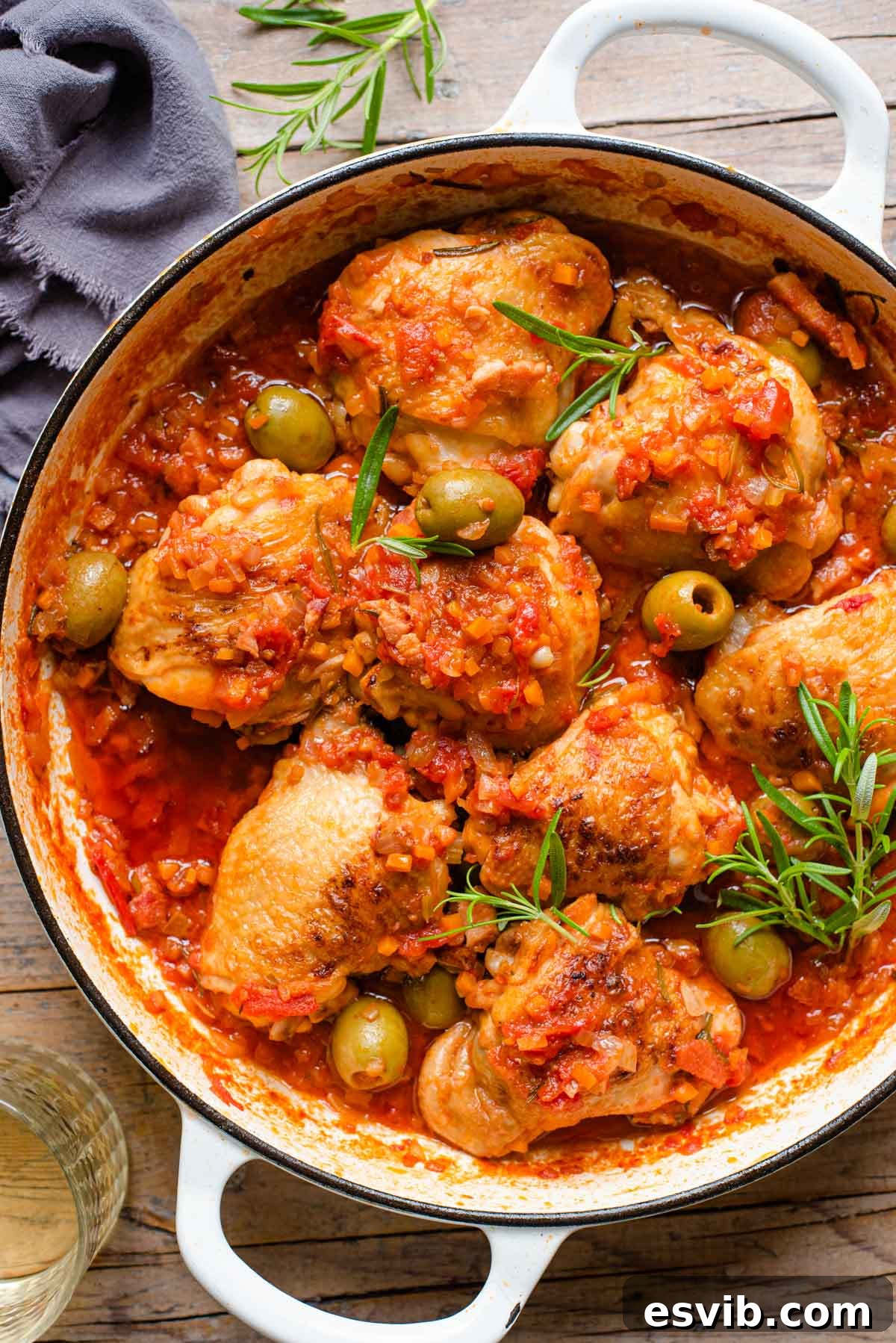 Rustic Hunter's Chicken 2 An overhead shot of chicken cacciatore in a large white casserole dish on a wooden background