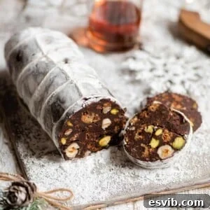 A close up of a chocolate salami cut into slices, ready to be served.