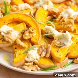 A close up of roasted butternut squash and gorgonzola on a serving plate