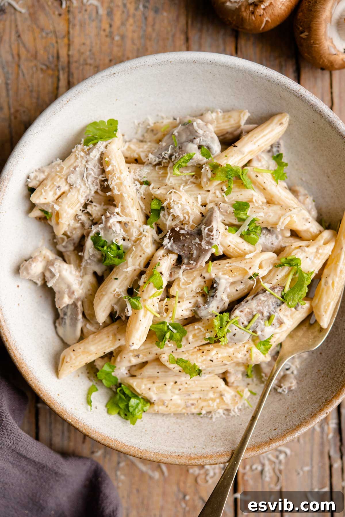 A beautifully plated dish of Pasta alla Boscaiola with rich creamy sauce, sausage, and mushrooms.
