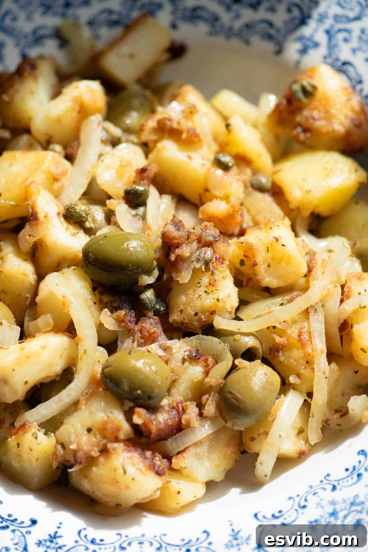 Savory Sicilian Potato Medley 4 A close up of a potato side dish with olives, capers and oregano.