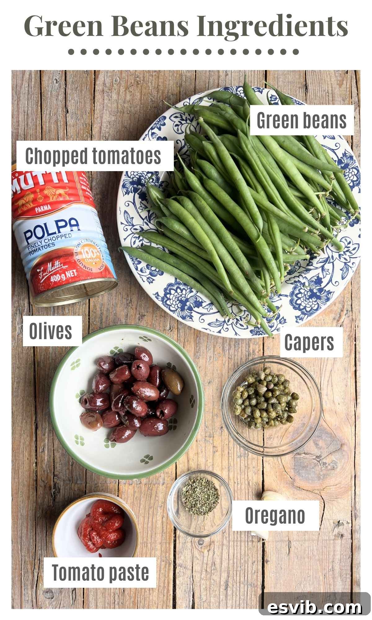 Zesty Green Beans with Olives and Capers 3 Canned tomatoes, green beans, olives, capers, oregano and tomato paste laying out on a rustic wooden board.