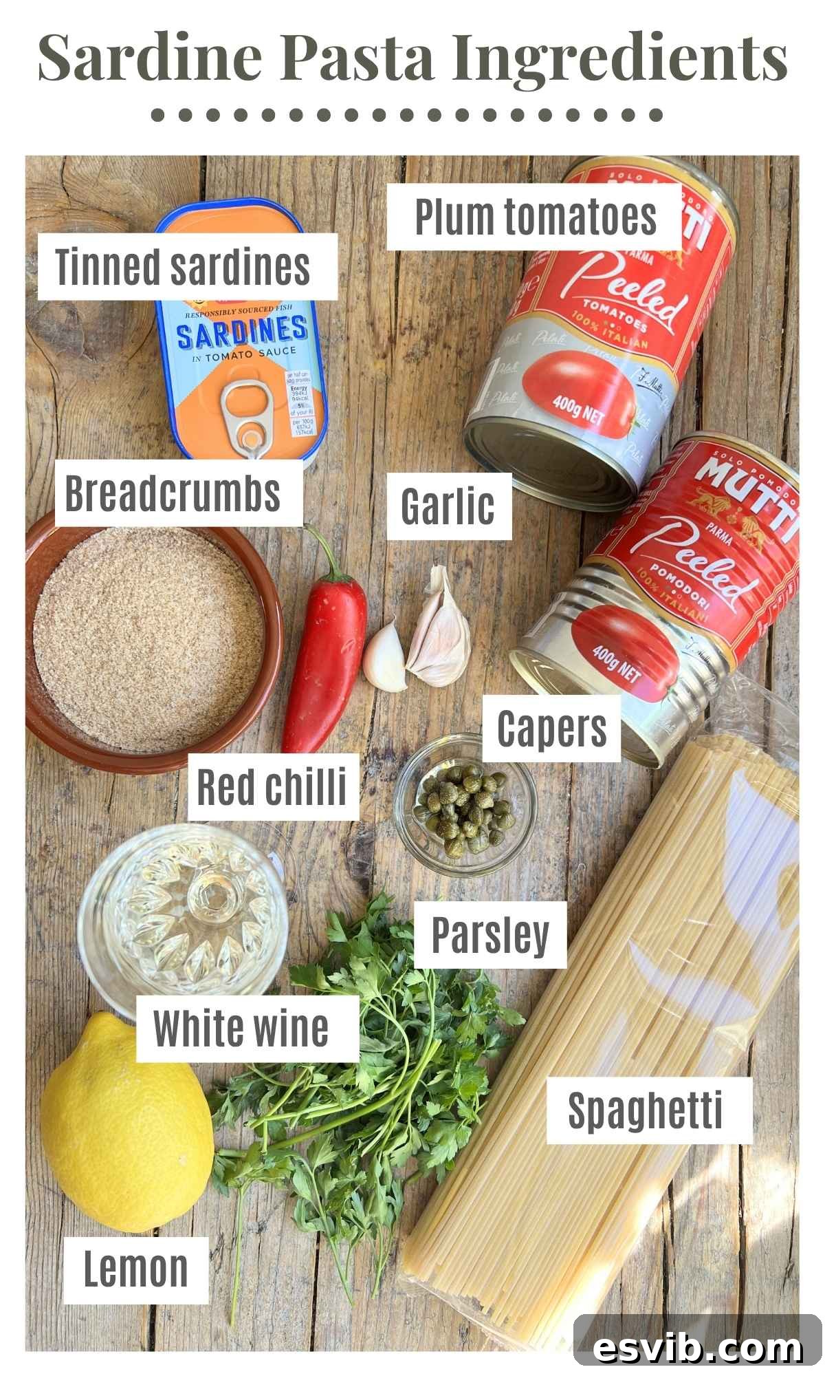 Golden Crumb Sardine and Tomato Pasta 3 An overhead shot of all the ingredients needed to make sardine pasta with tomatoes, chilli, and breadcrumbs, laid out on a surface.