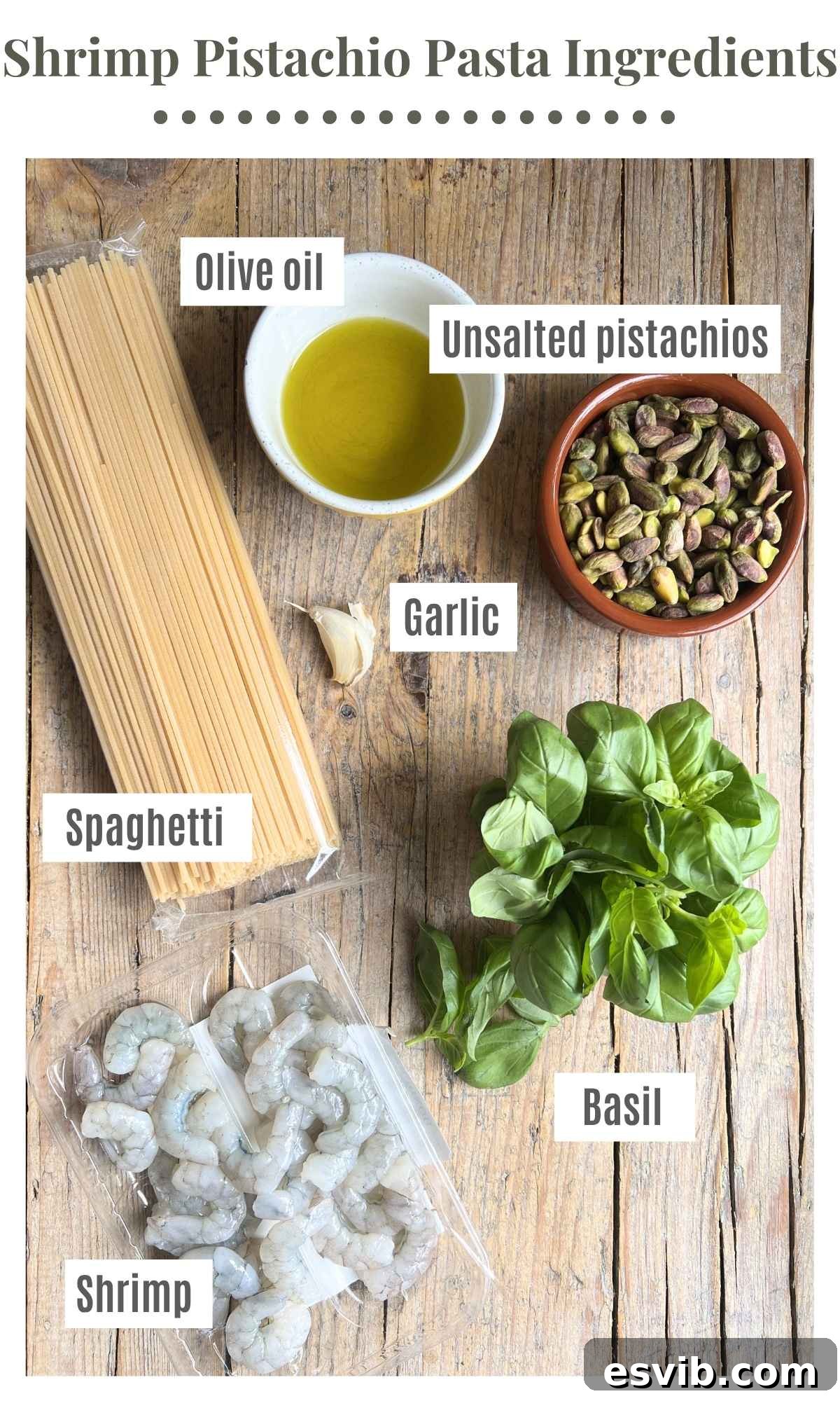 Emerald Coast Pistachio Shrimp Pasta 3 An overhead photograph displaying all the ingredients needed for Sicilian pistachio shrimp pasta, including spaghetti, pistachios, basil, shrimp, garlic, and olive oil.