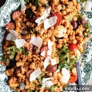 A close up of sun-dried tomato pasta fredda on a serving plate.