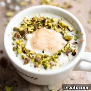 A close up cropped image of a pistachio affogato in a white mug.