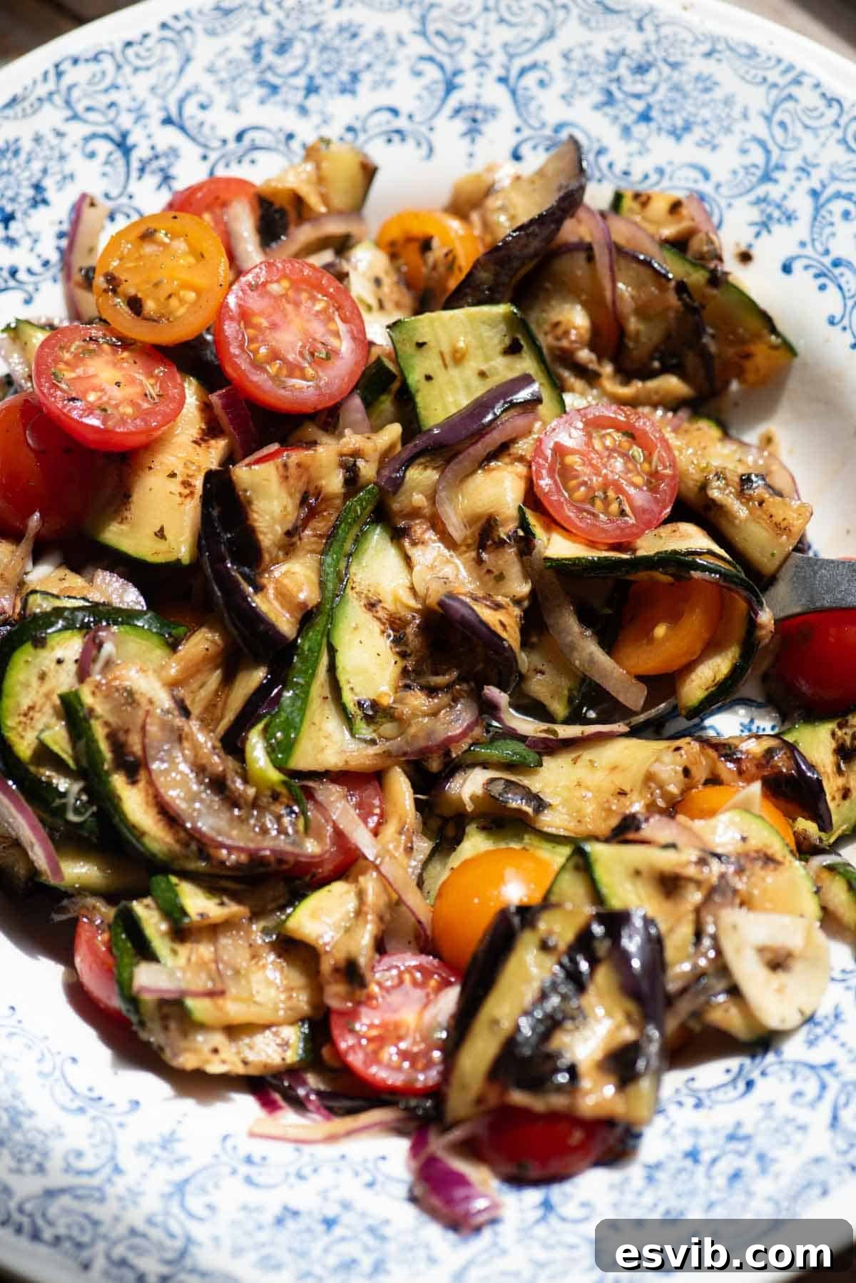 A close up of marinated grilled vegetables in a bowl.