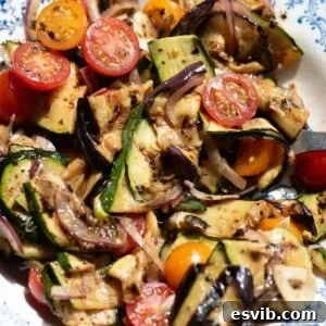 A close up of marinated summer vegetables in a bowl.