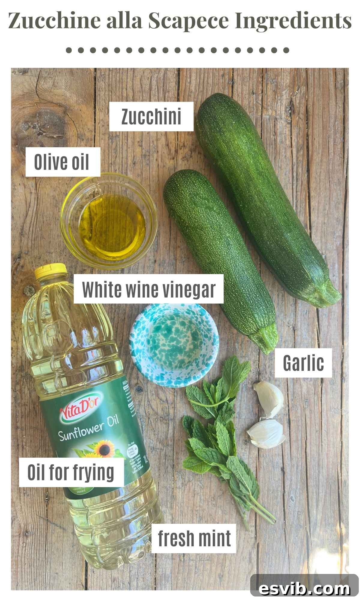 An overhead shot of all the ingredients needed to make zucchine alla scapece on a wooden board.
