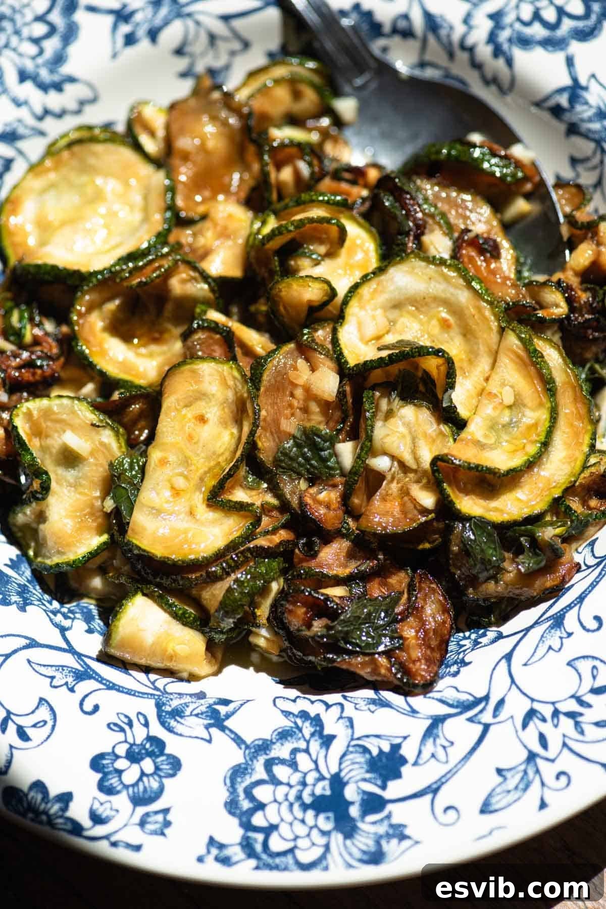 A close up of fried marinated zucchini in a blue bowl.