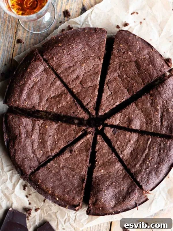 An overhead shot of an Italian flourless chocolate cake cut into slices.