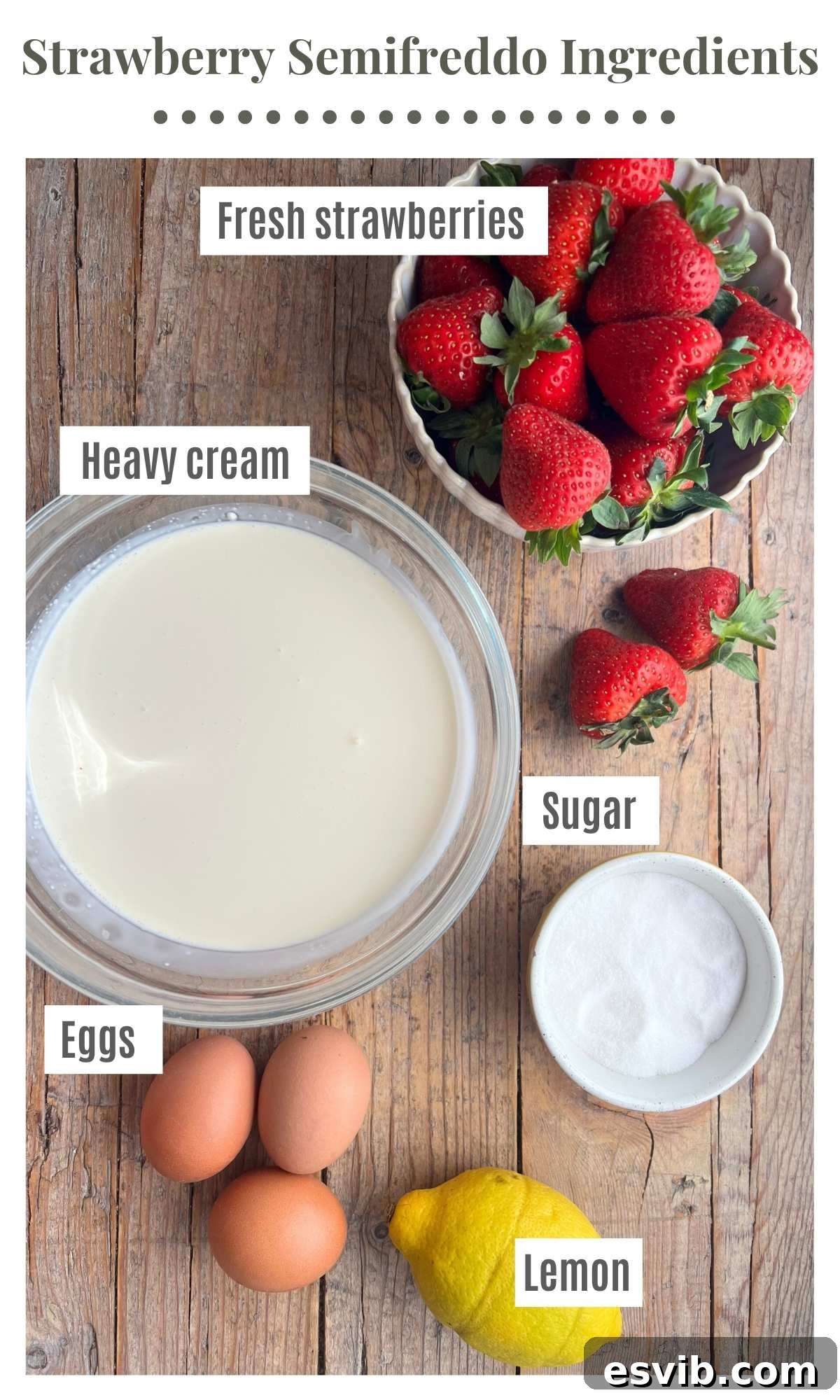 An overhead shot of all the ingredients needed to make strawberry semifreddo laying on a rustic wooden surface. Strawberries, cream, sugar, eggs and lemon.