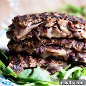 A close up of beef stuffed with cheese, radicchio and porchetta on a plate with arugula at the side.