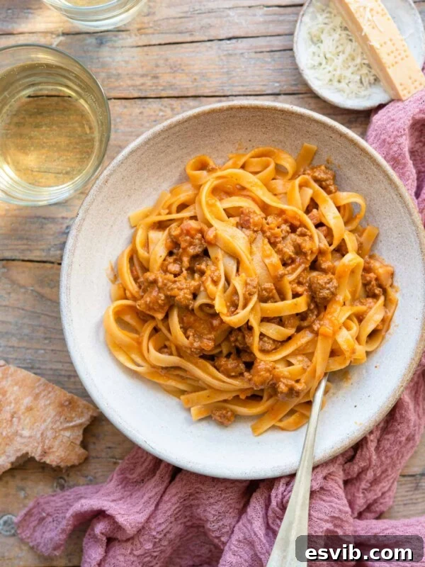 AN overhead shot of tagliatelle bolognese in a rustic bowl