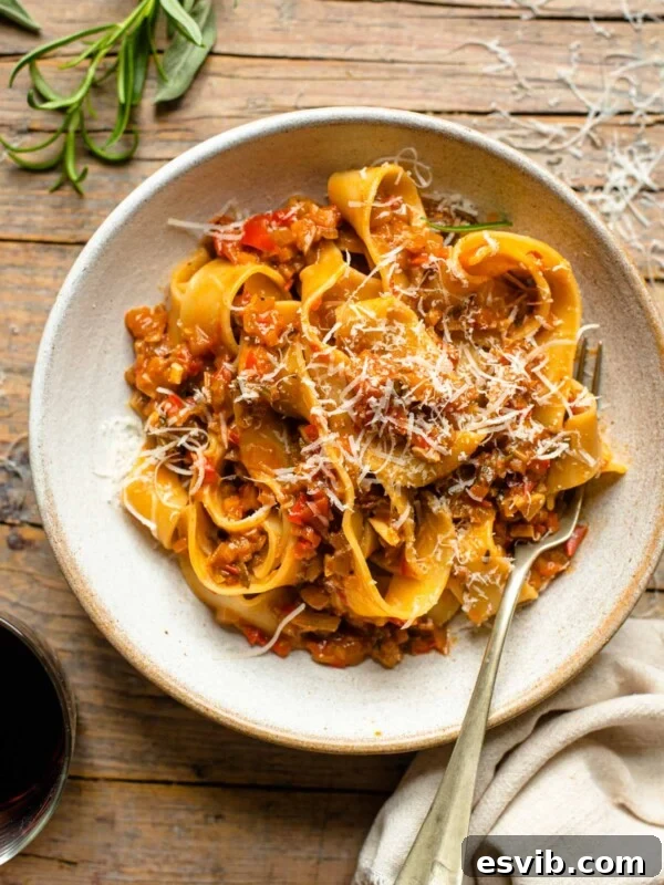 An overhead shot of a bowl of pasta on a wooden surface
