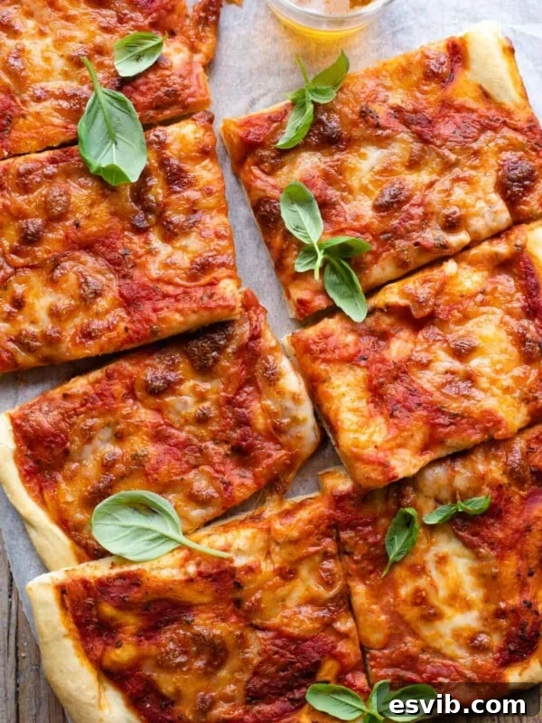 An overgead shot of a focaccia pizza cut into slices