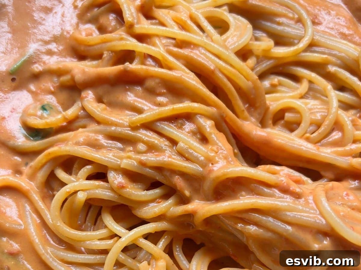 A close up of roasted cherry tomato and ricotta pasta.
