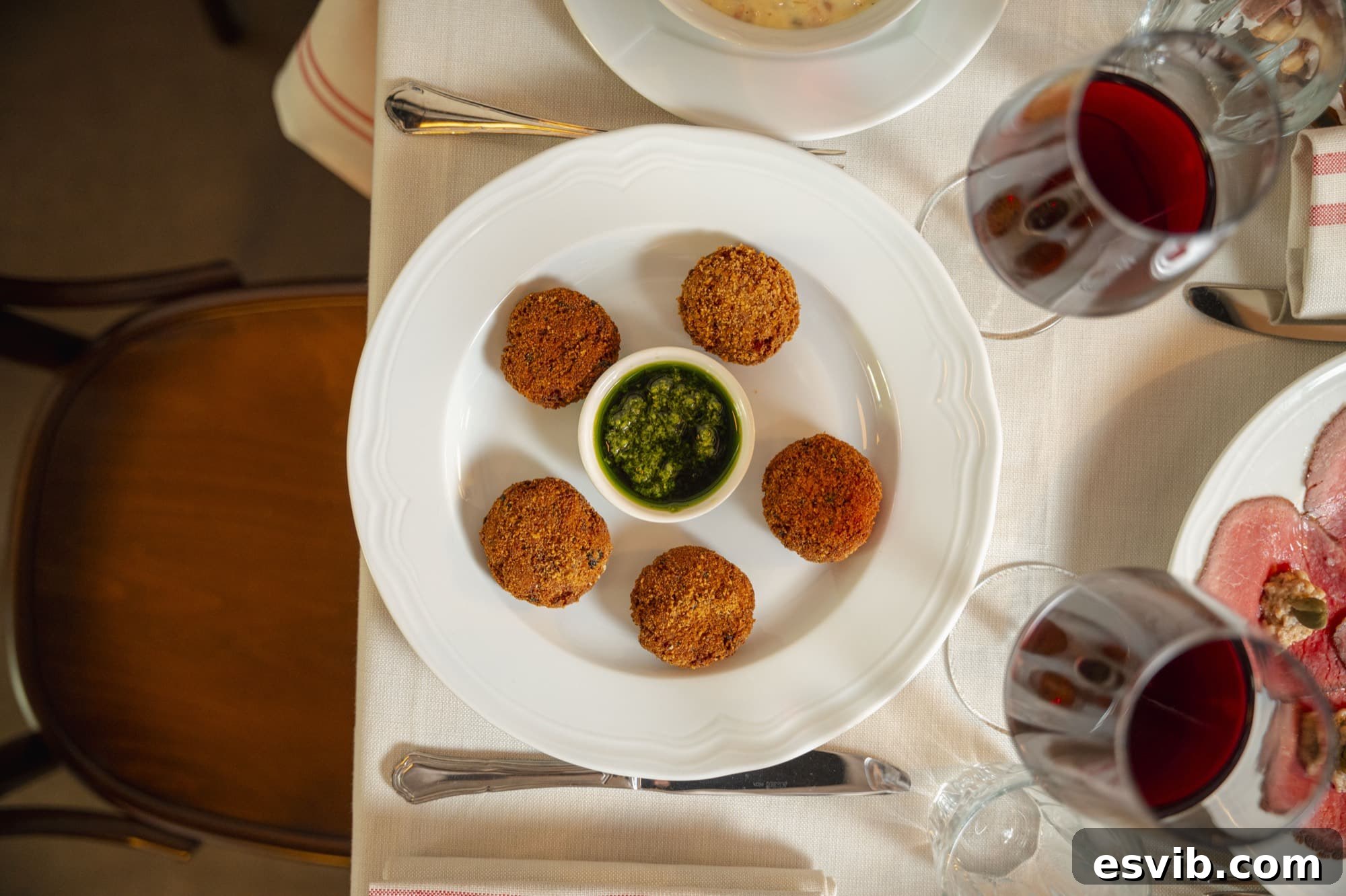 Gianmarco Senna on Lombardy's Agenda 3 Mondeghili on a plate in a restaurant.