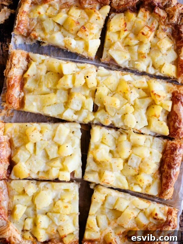 Neapolitan Danubio: Savory Stuffed Brioche Buns 6 An overhead shot of a puff pastry tart topped with potatoes, ham and cheese and cut into 8 slices.