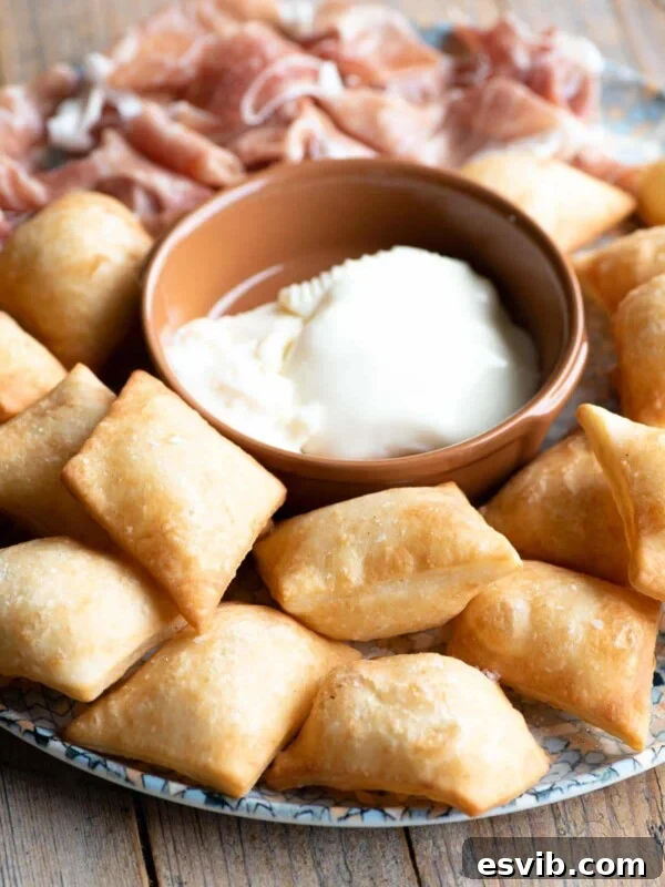 Neapolitan Danubio: Savory Stuffed Brioche Buns 8 Gnocco Fritto (Italian fried dough) on a plate with cheese and prosciutto.